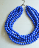 A beaded multi strand statement necklace made with cobalt blue acrylic beads.