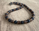 Necklace with brown and black beaded design on a wooden surface