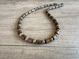 DLD Jewelry's Terrance mens wood and carved jade beaded necklace arranged on wood with a gunmetal lobster clasp.”
