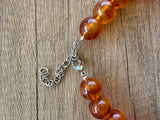 Close-up of the Betty necklace’s stainless steel lobster clasp and extender chain