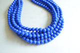 A beaded multi strand statement necklace made with cobalt blue acrylic beads.