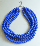 A beaded multi strand statement necklace made with cobalt blue acrylic beads.