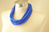 A beaded multi strand statement necklace made with cobalt blue acrylic beads.